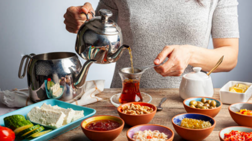 a woman using a Caydanlik to serve Tea