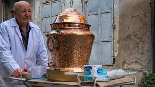 Man selling Salep on street from a traditional copper container on a rolling cart