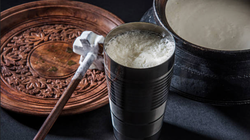 homemade ayran on a table with the blender bit on the side.  