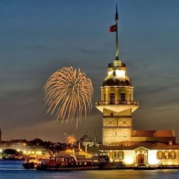 Maiden's tower on the Bosphorus at night with fireworks in the background. 