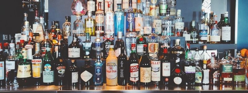 a collection of liquors at a bar