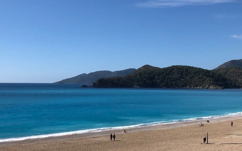 nearly empty Ölüdeniz Beach on a sunny day