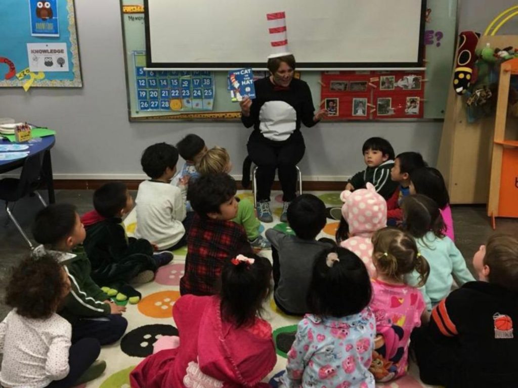 Pafoua reading Cat in the Hat to the children