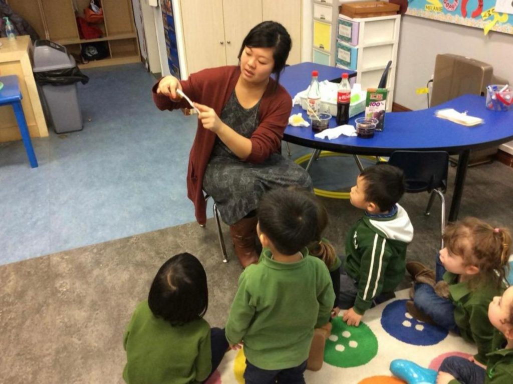 Pafoua demonstrating something to the children