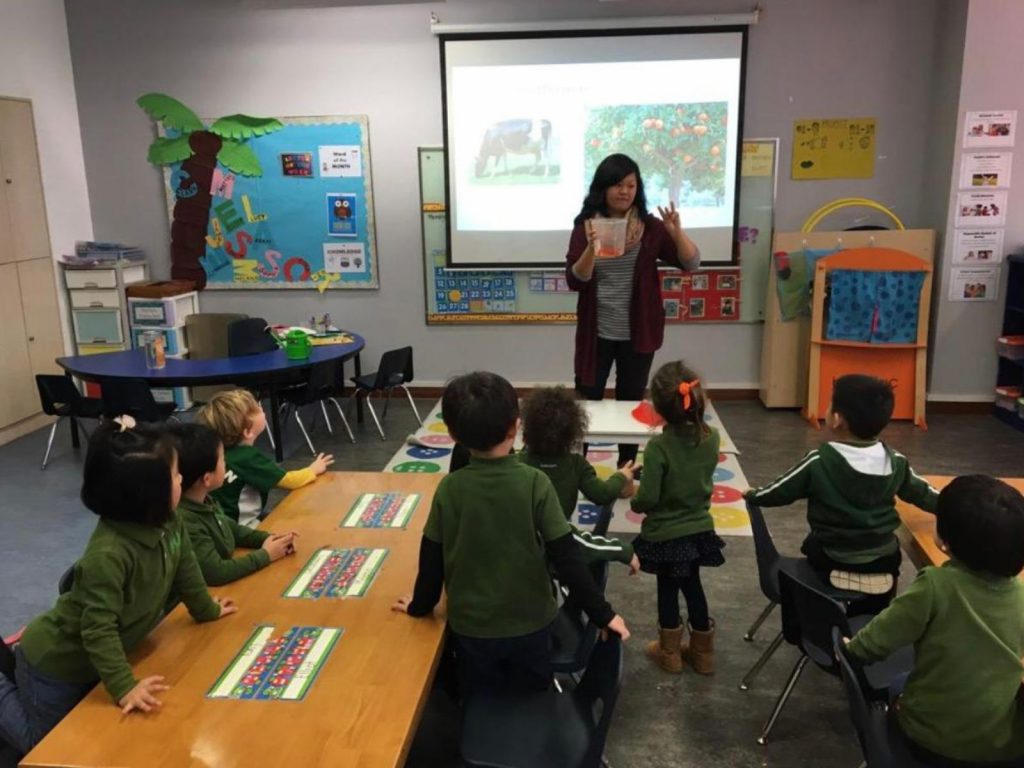 Pafoua teaching a classroom of children