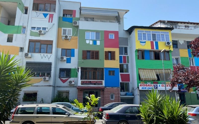 colorful buildings with banners painted on them in Tirana, Albania