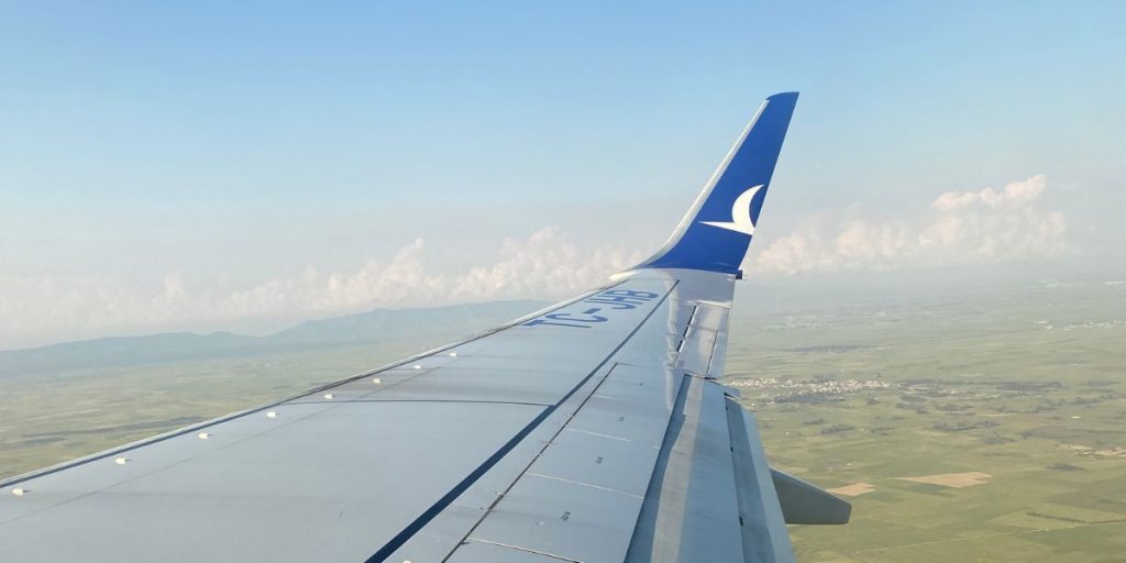 Airplane wing while flying through the passenger window