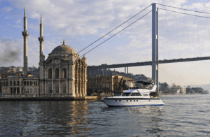 Yacht on the Bosphorus with a mosque and a bridge in the background