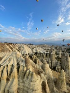 Blue skies and fairy chimneys as the hot air balloons pass overhead