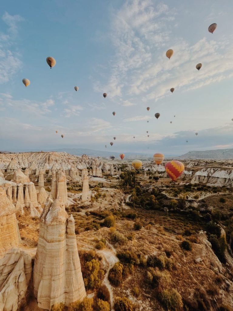 Morning hot air balloon ride over the Cappadocia fairy chimneys with dozens of other hot air balloons.