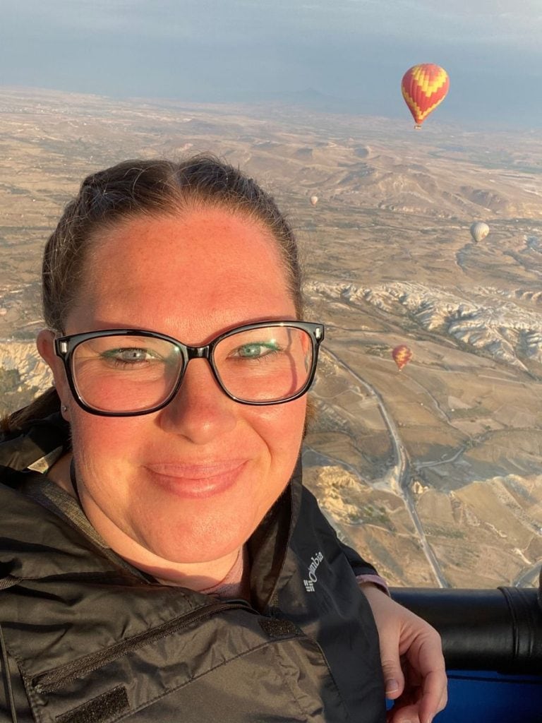 kimberly on a hot air balloon ride in Cappadocia with the another hot air balloon in the background