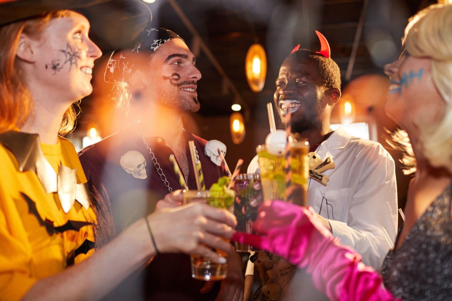 Group of people standing around in costumes with drinks in their hands - Does Turkey celebrate Halloween