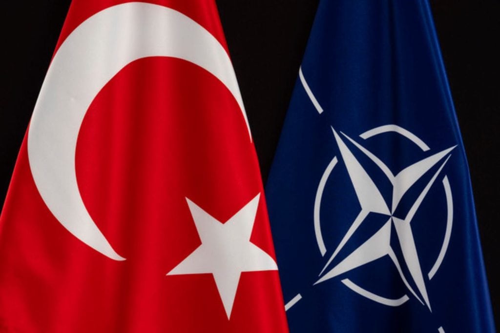A Turkish flag next to a NATO flag