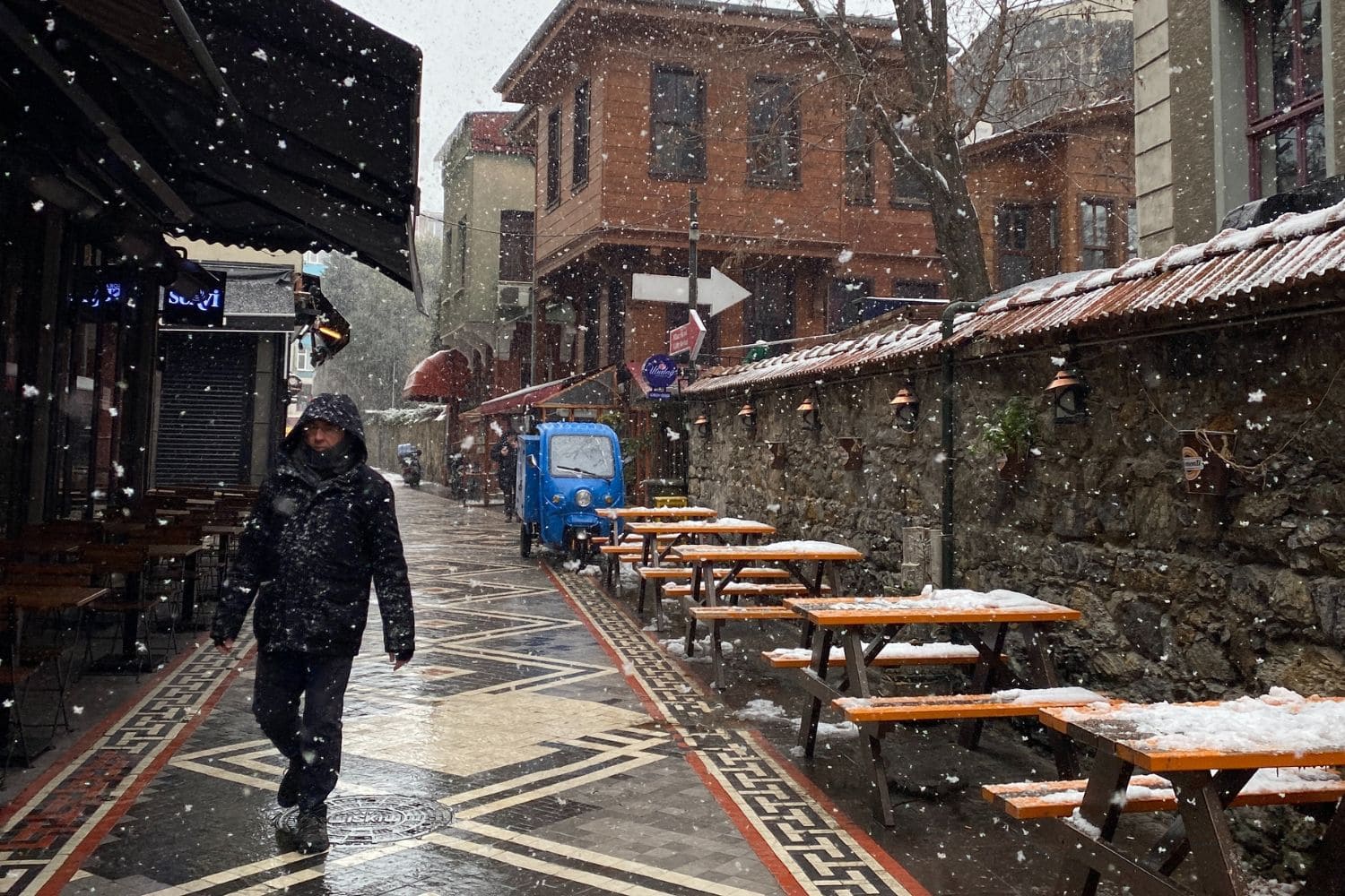 a man experiences Winters in Turkey as he walks in the lightly falling snow