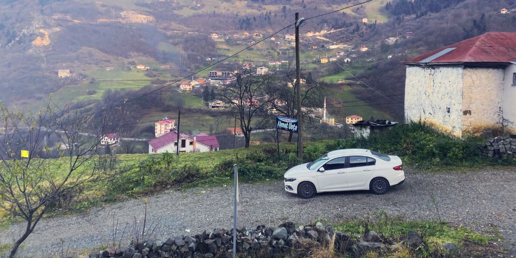 our rental car on the side of the road in hamsikoy overlooking the valley.