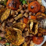 Platter of multiple types of kebabs. Chicken wings, adana kebabs, lamb kebabs, small lahmucun and roasted tomatoes and peppers with onions sprinkled with sumak. Turkey National Dish