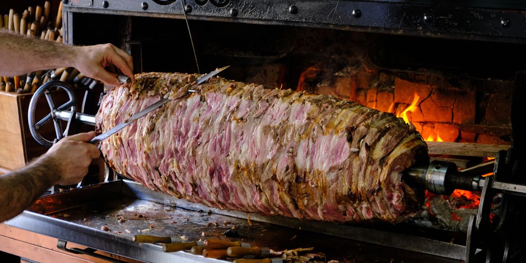 Cag kebab - meat roasted horizontally in front of a fire