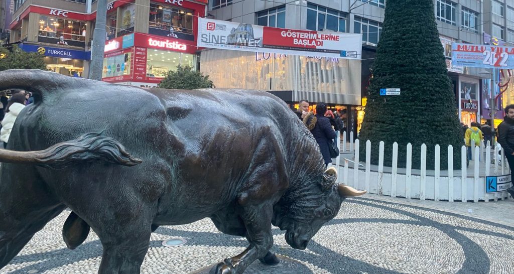 Kadıköy bull at Christmas time with a Christmas tree in the background