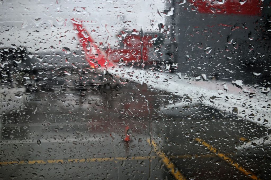 Window of an airplane covered in rain of Turkish Airlines flight