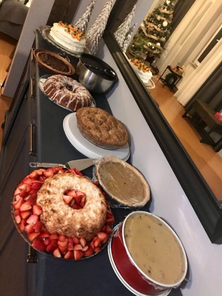 dessert at a Thanksgiving feast including cheesecake, angel food cake with strawberries, carrot cake and of course pumpkin pie