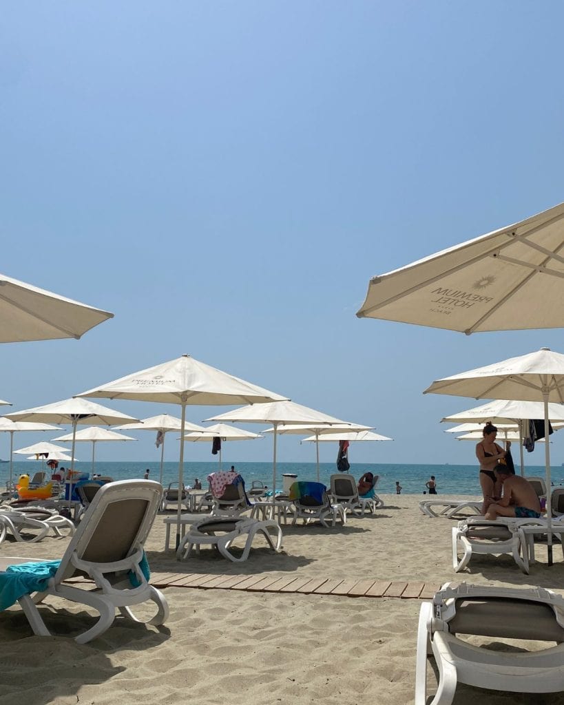 Beach resort in Durres, Albania with a bunch of sun bathing chairs and umbrellas. 