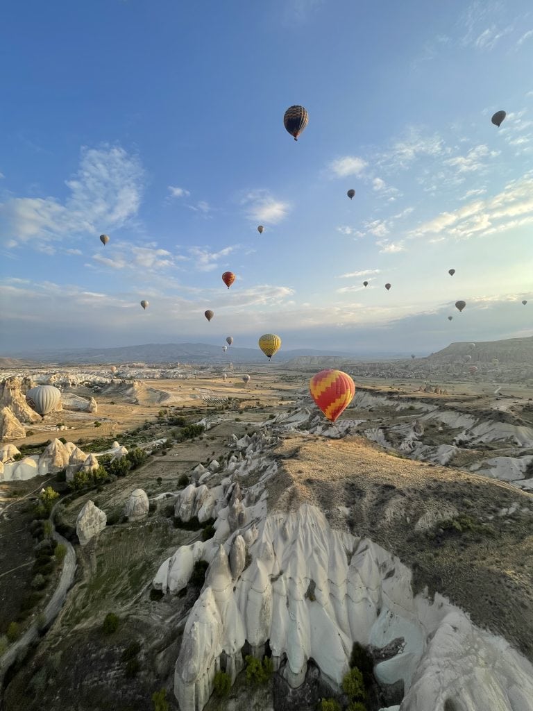 Beautiful view of the Cappadocia valley with the hot air balloons flying in the morning sky