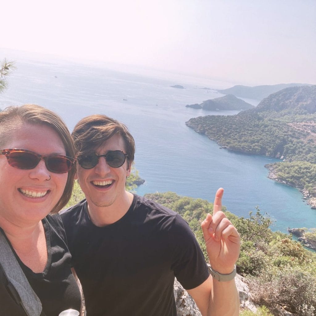 Jordan and Kimberly on the hike from Kayakoy to Oludeniz with the beautiful cove of brilliant blue water in the background