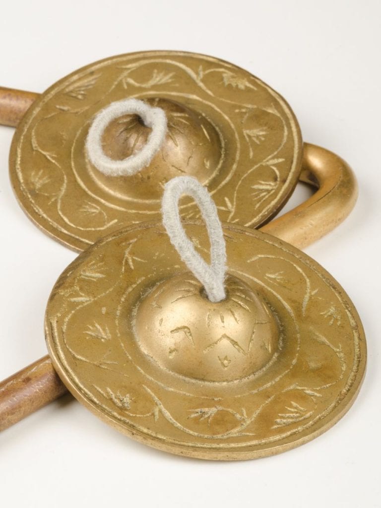 gold finger cymbals that are used by belly dancers