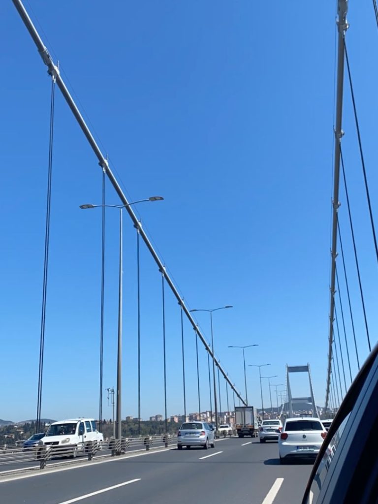 Driving along the suspension bridge in Istanbul, headed toward the European side on a clear, sunny day. 