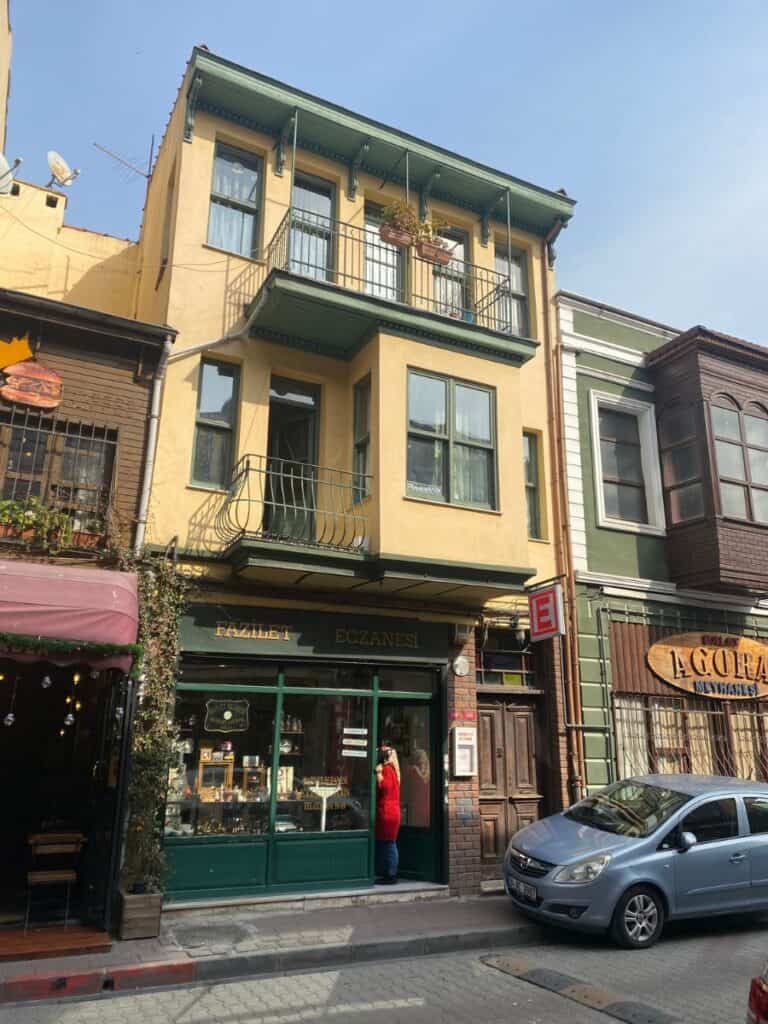historical eczanesi/pharmacy in a yellow building with green trim on a sunny day