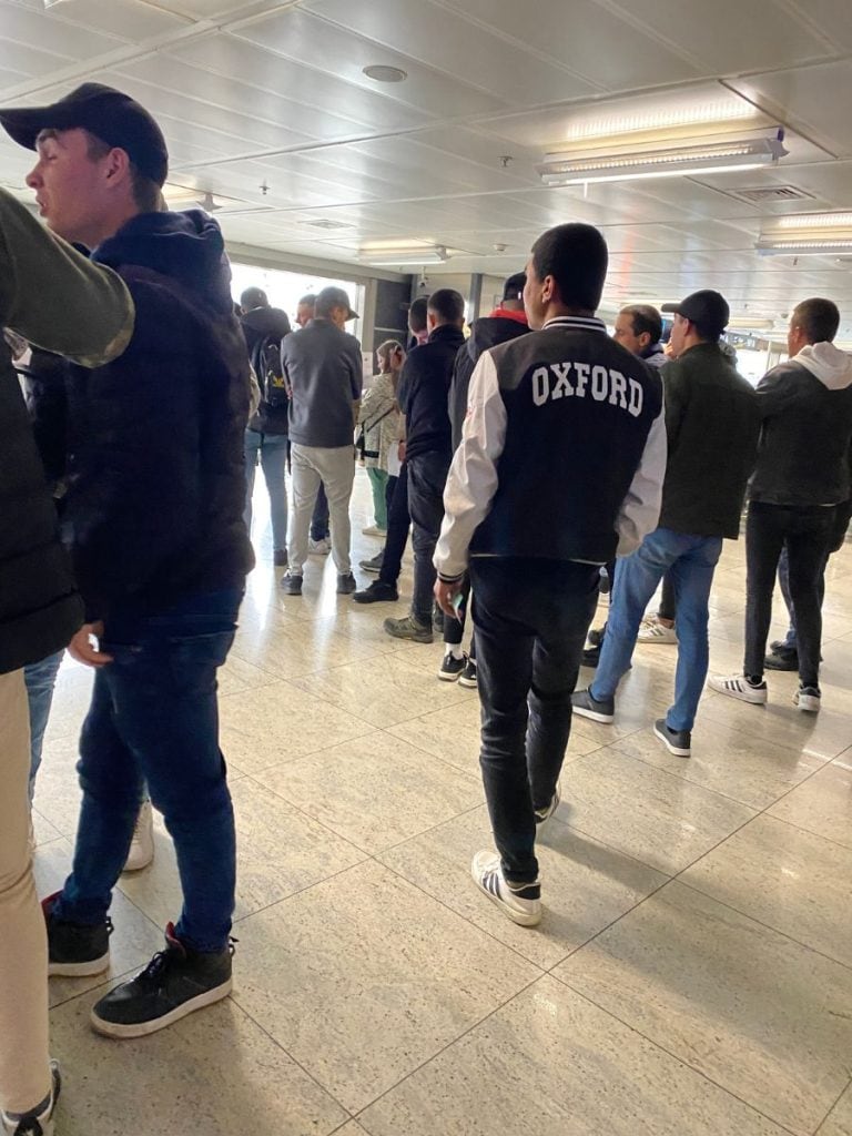 a mass of men at the airport. 