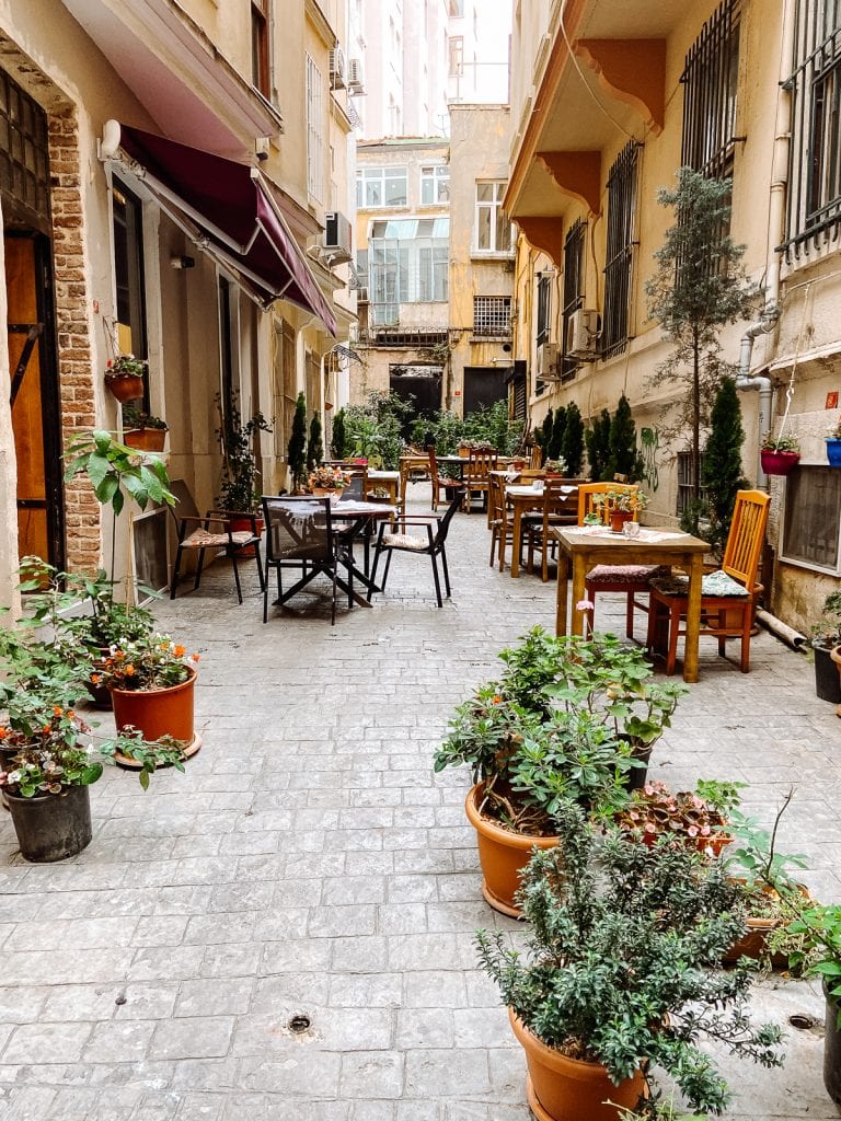 Cafe Privato's private alley with coffee tables and chairs.
