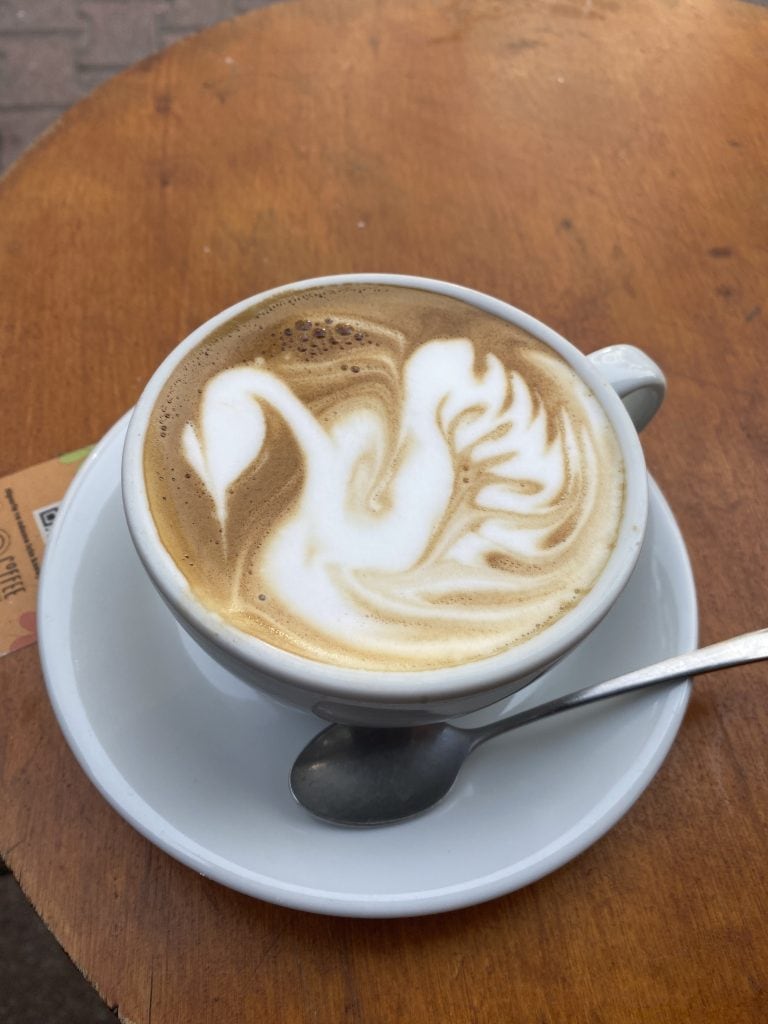 latte at Glow coffee with a swan art
