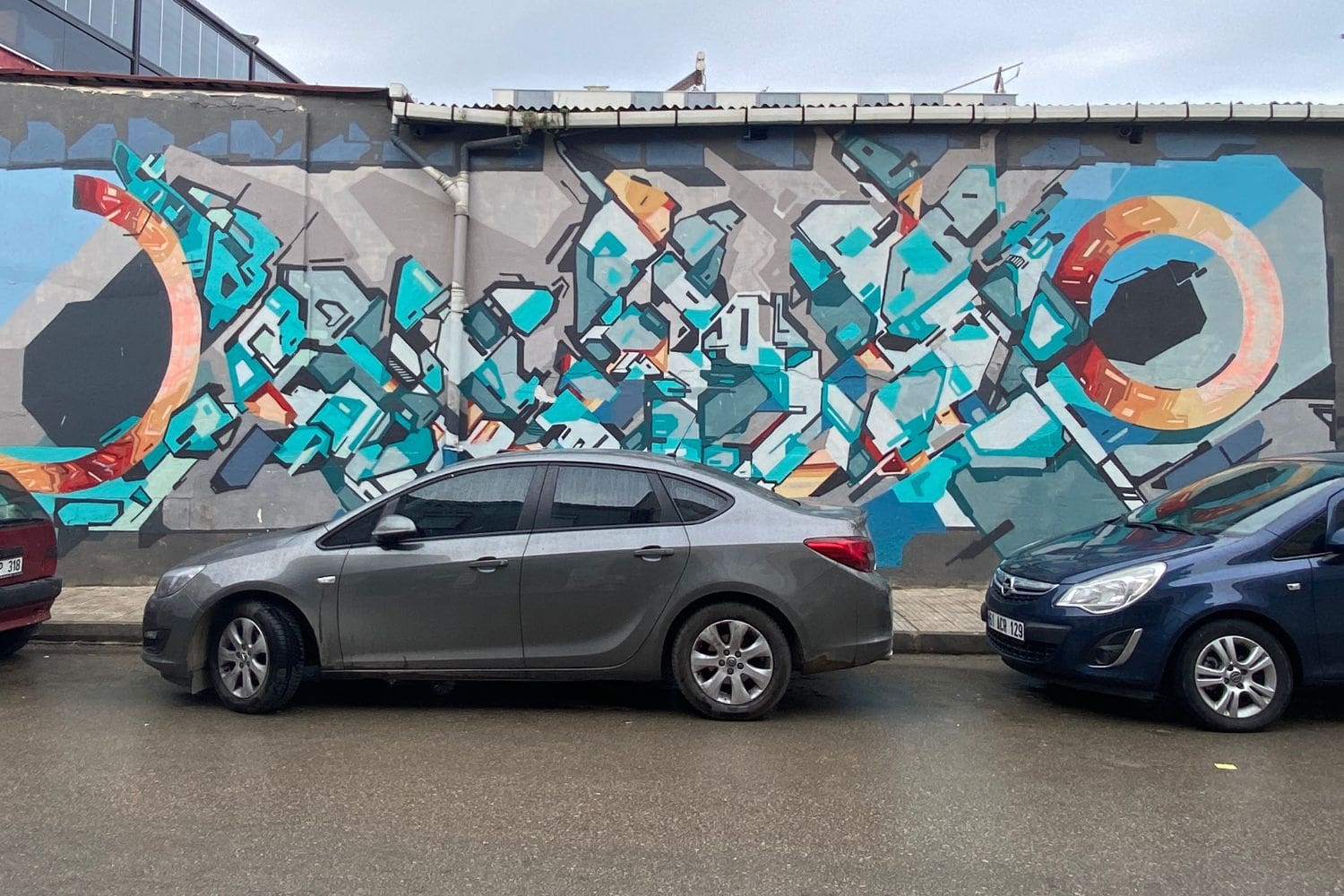 car rental istanbul airport can be parked streetside like this one with a graffiti wall in the background.