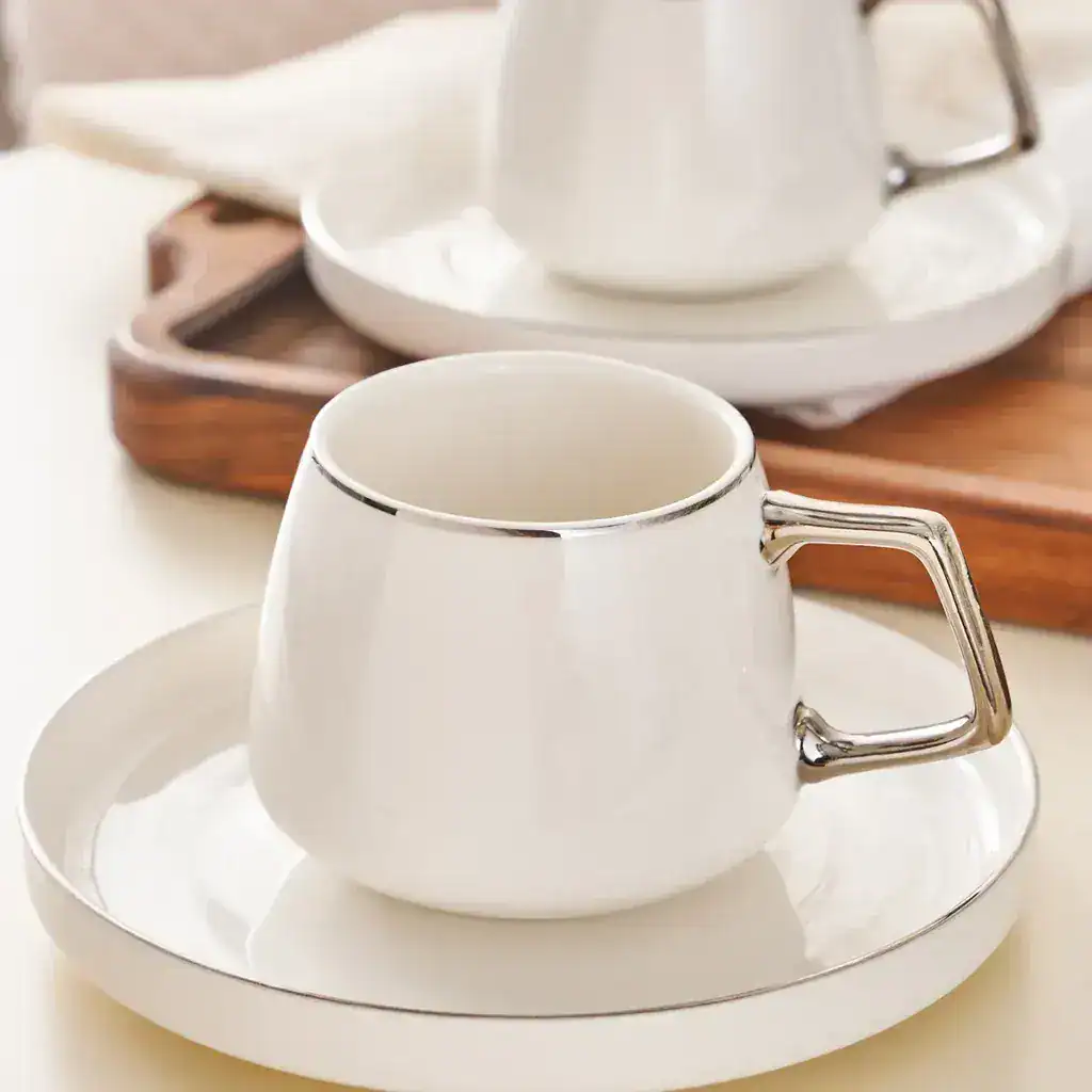 two Karaca Saturn turkish coffee cups on saucers