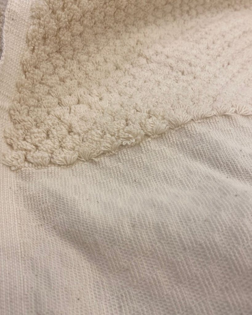 upclose shot of a white thick-looped towel. 