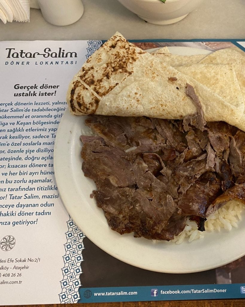 doner on top of rice with a bread