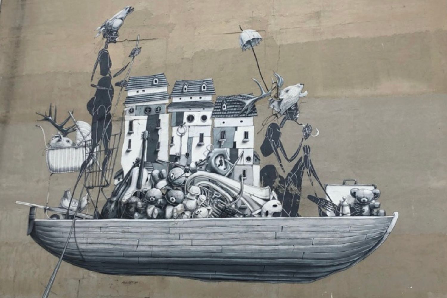 street art in Kadıköy with a picture of some buildings and people like characters in a boat