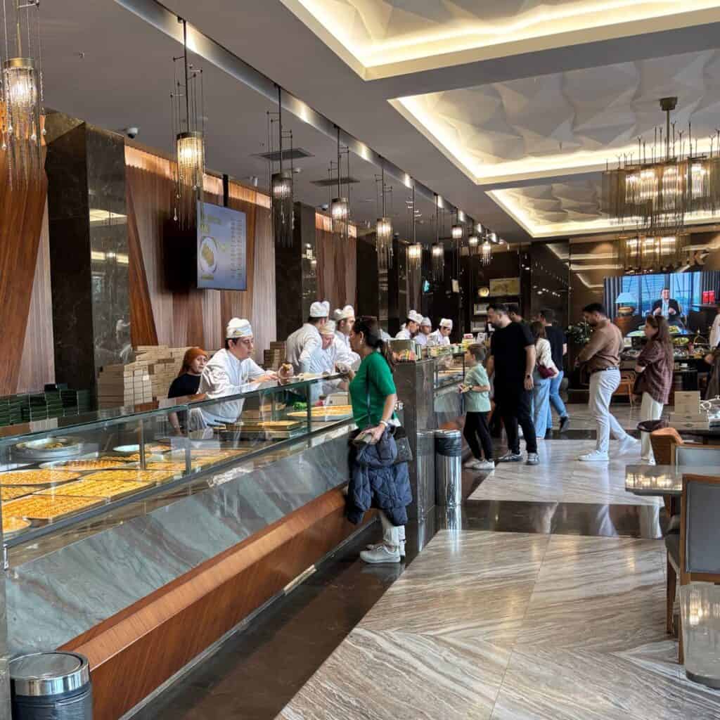 A busy counter at a baklava pastry shop in Gaziantep, Turkey.